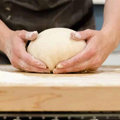 hands working bread dough