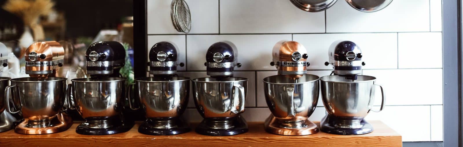 row of metal stand mixers